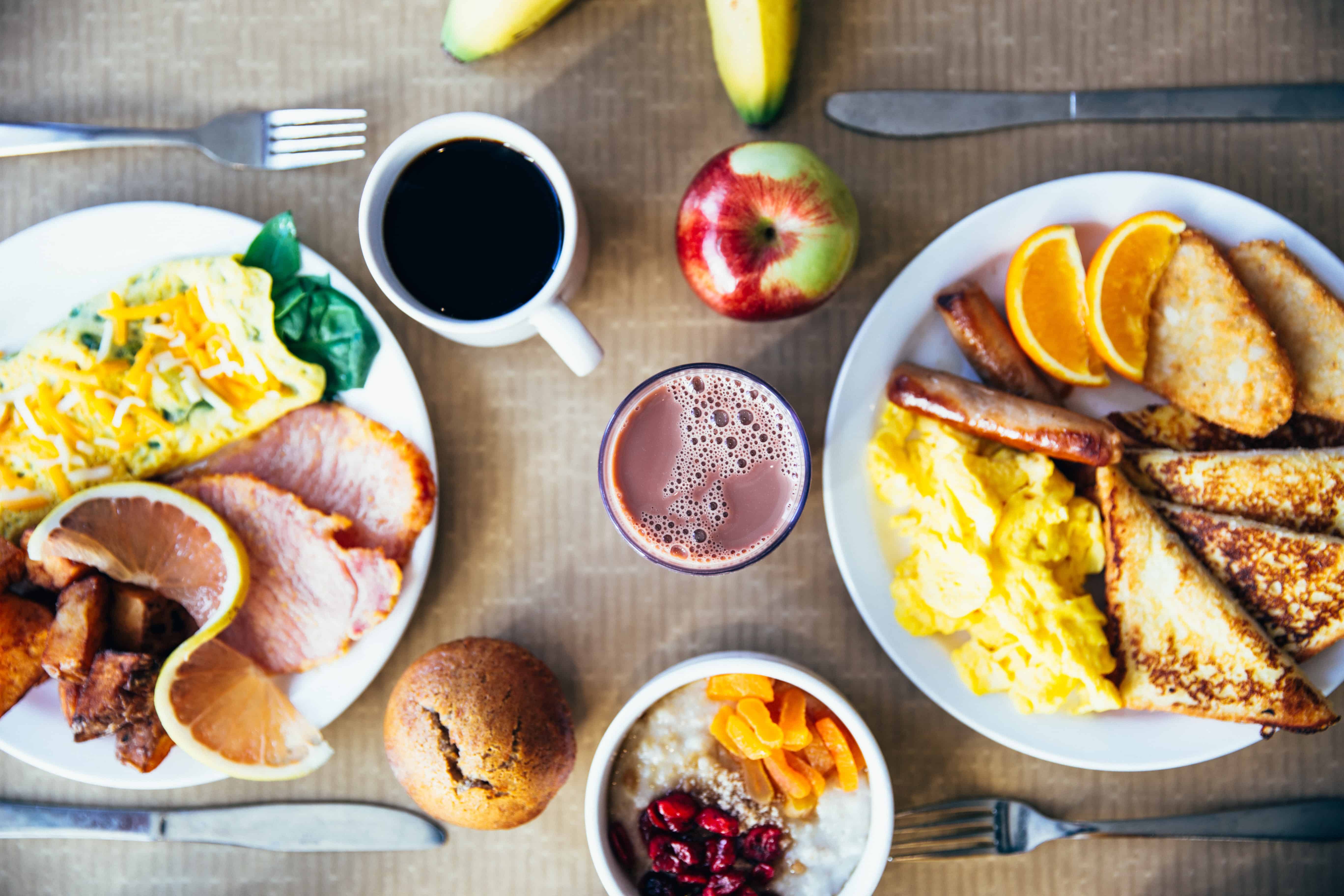 Coffee, bread and other breakfast items on a table.