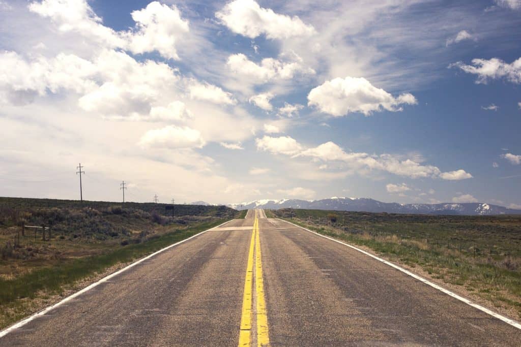An open road with sky and clouds.